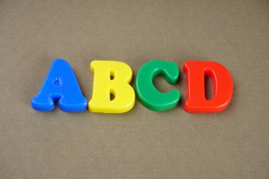 ABCD letters on brown background  