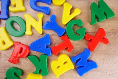 Colorful alphabet letters on wooden background