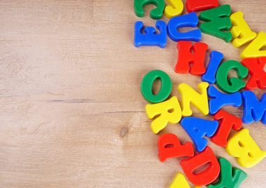 Colorful alphabet letters on wooden background