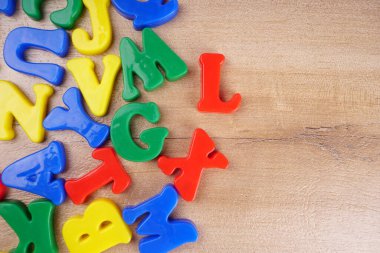 Colorful alphabet letters on wooden background