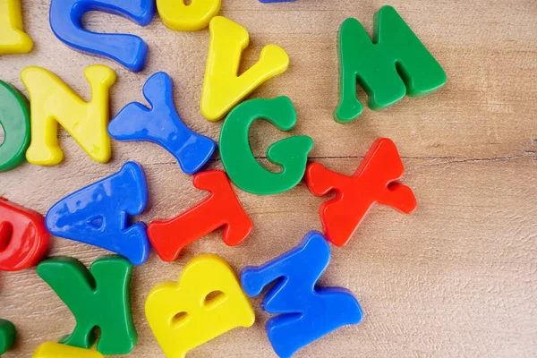 Colorful alphabet letters on wooden background