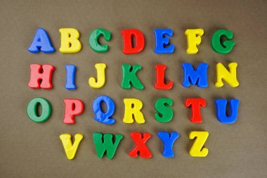 Colorful English alphabet on brown background