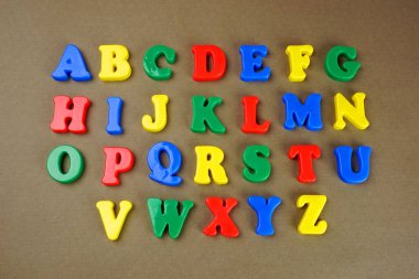 Colorful English alphabet on brown background