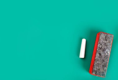 Chalk and washcloth on green background