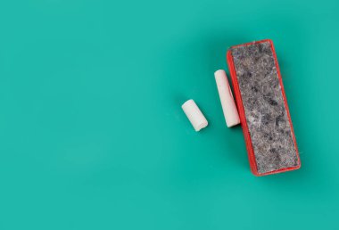 Chalk and washcloth on green background