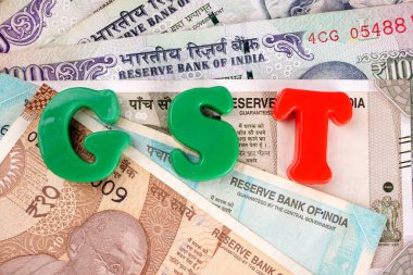 'GST' word with money banknotes