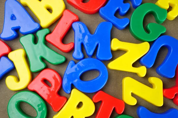 Colorful English alphabet on brown background