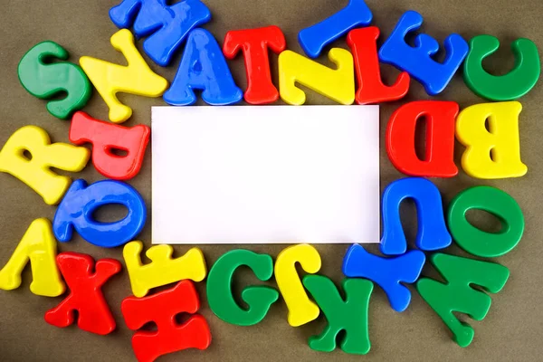 Colorful English alphabet with empty white paper for copy space
