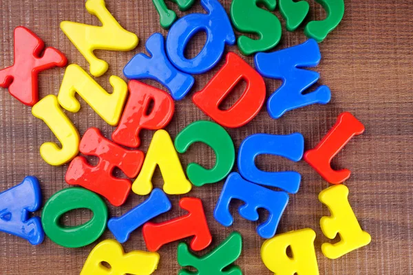 Colorful alphabet letters on wooden background