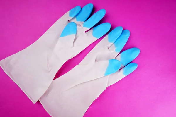 Rubber gloves on pink background