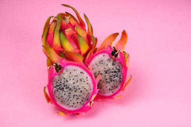 Fresh ripe dragon fruit on pink background