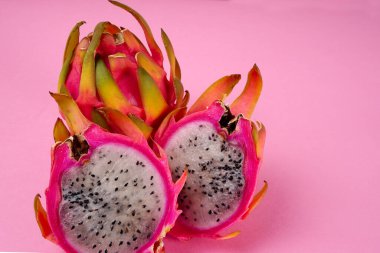 Fresh ripe dragon fruit on pink background
