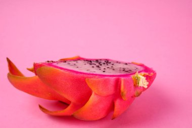 Fresh ripe dragon fruit on pink background