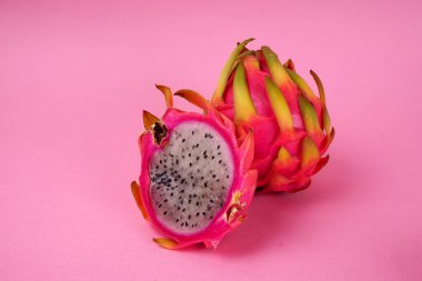 Fresh ripe dragon fruit on pink background