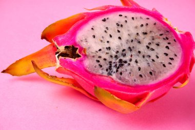 Fresh ripe dragon fruit on pink background