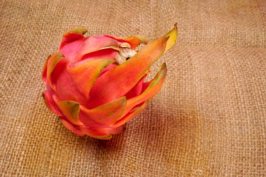 Fresh ripe dragon fruit on sack background