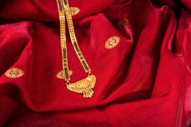 Mangalsutra or Golden Necklace to wear by a married hindu women, arranged with beautiful backgrond. Indian Traditional Jewellery.