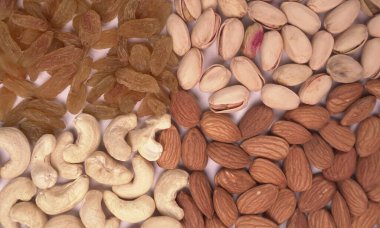 Variety mix of dried fruits and nuts on white background. Concept of Healthy fitness super food