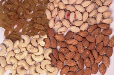 Variety mix of dried fruits and nuts on white background. Concept of Healthy fitness super food