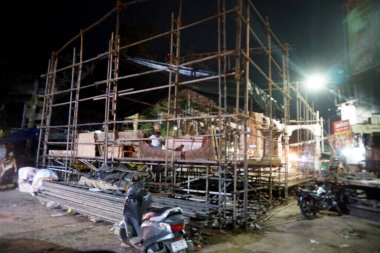 Building construction in Indian city at night