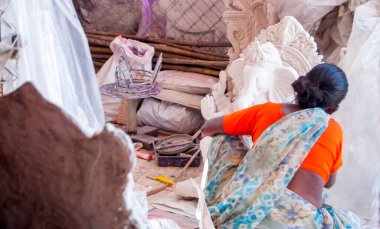 Indian woman making Ganesha Hindu statue