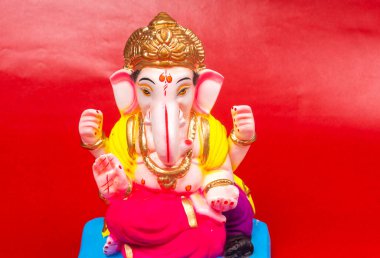 Kırmızı arkaplanda Ganesha Hindu heykeli