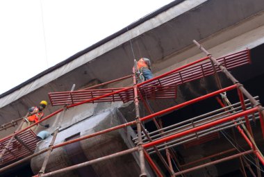 Bottom view of workers in construction site