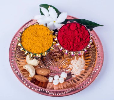 Beautifully Decoration for festival celebration to worship, haldi or turmeric powder and kumkum, flowers with leaves.Copy space.