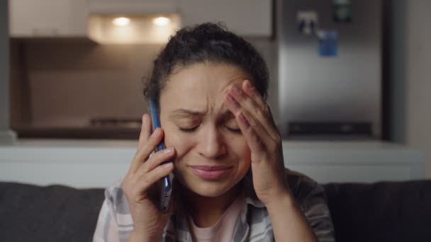 Anxious woman having call using phone getting bad news at home alone — Stockvideo