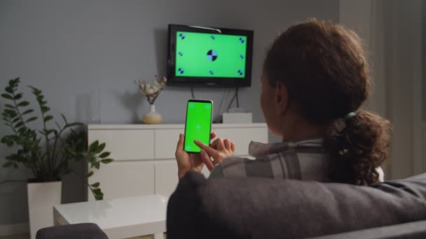 Adult woman applying TV wireless mobile app at home, chroma key mockup — Stockvideo