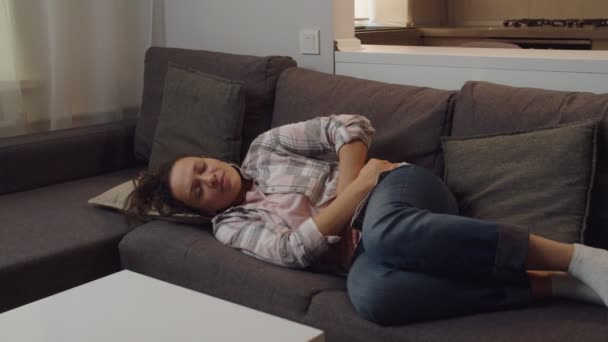 Adult female embracing belly, suffering from stomachache indoors — Stock videók