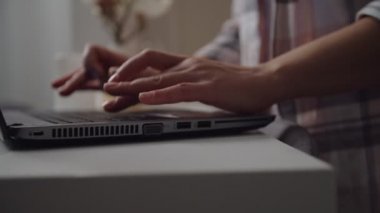 Close-up of woman working, writing email, online messaging indoors