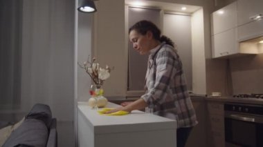 Housewife getting lost in contemplation while household chores indoors