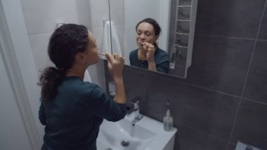 Güzel siyah kadın doğal bambu eko fırçasıyla ağzını temizliyor.