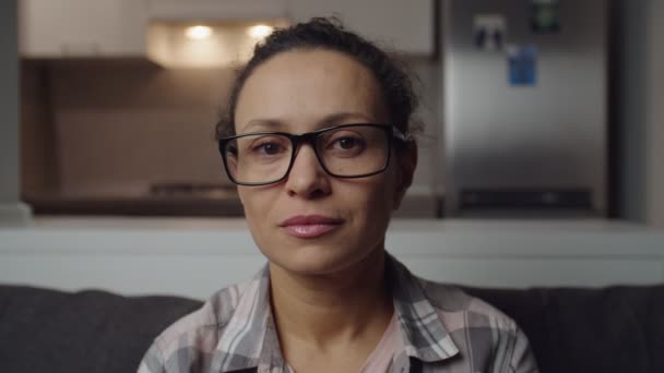 Woman in eyeglasses turning head to camera lowering eyeglasses smiling — Stockvideo