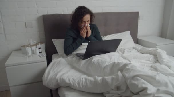 Diseased adult woman having video call while illness at home — Stockvideo