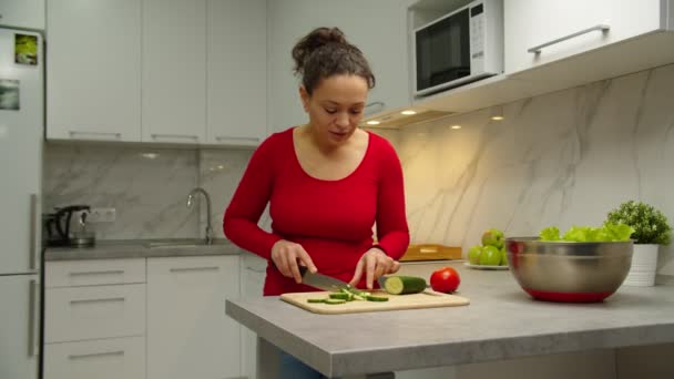 Lächelnder süßer Junge überreicht Blumen an geschäftige Mutter im Haus — Stockvideo