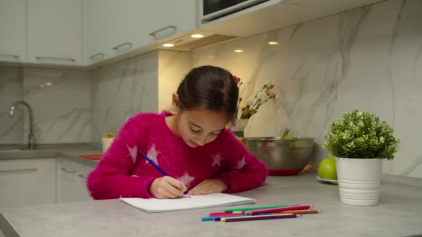 Очаровательная девочка-подросток рисует альбомы с цветными карандашами дома — стоковое видео