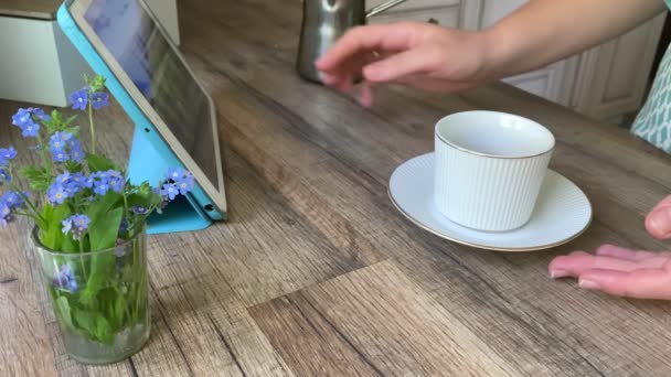 Unrecognizable woman using tablet drinking coffee at home — Videoclip de stoc