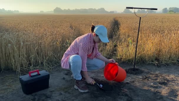 Female Agronomist Taking Sample Garden Tool Putting Soil Bucket Agricultural — Stockvideo