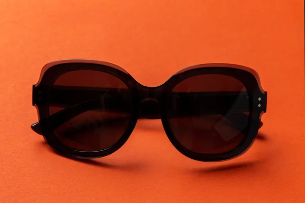 Schwarze Sonnenbrille Auf Orangefarbenem Hintergrund Draufsicht Flache Lage Minimalistisches Konzept — Stockfoto