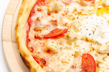 Fresh homemade Italian pizza, fast food cheese, tomato sauce, tomato and other ingredients portion on the table healthy meal snack outdoor. Top view.