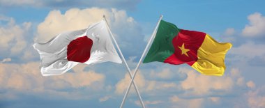 Japonya ve Kamerun 'un bayrak direkleri rüzgarda dalgalanırken güneşli bir günde gökyüzüne karşı bulutlar. İki ülke arasındaki ilişkiyi, diyaloğu sembolize ediyor. 3d illüstrasyon,