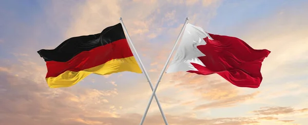 Flaggor Tyskland Och Bahrain Vinkar Vinden Flaggstänger Mot Himlen Med — Stockfoto