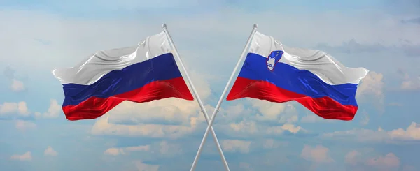 러시아와 슬로베니아의 국기가 위에서 하늘을 바람에 흔들리고 관계를 상징하고 나라간의 — 스톡 사진