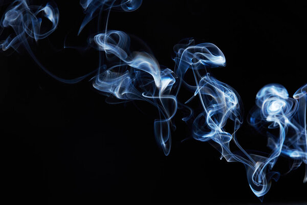 Blue smoke on black background with abstract blur motion wave swirl . Wisp of Smoke. Cigarette smoke waves and clouds texture
