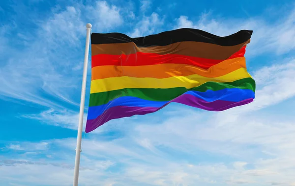 Philadelphia Pride flag waving in the wind at cloudy sky. Freedom and love concept. Pride month. activism, community and freedom Concept. Copy space. 3d illustration.