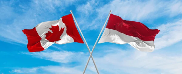 Cruzou Bandeiras Nacionais Canadá Indonésia Agitando Vento Céu Nublado Simbolizando — Fotografia de Stock