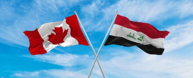 Kanada ve Irak 'ın ulusal bayraklarını aştı bulutlu gökyüzünde rüzgarda sallanıyor. İlişkiyi, diyaloğu, iki ülke arasında seyahat etmeyi sembolize ediyor. Boşluğu kopyala