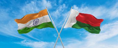 Hindistan 'ın ulusal bayraklarını aştı ve Madagaskar bayrağı bulutlu gökyüzünde rüzgarda dalgalanıyor. İlişkiyi, diyaloğu, iki ülke arasında seyahat etmeyi sembolize ediyor. Boşluğu kopyala